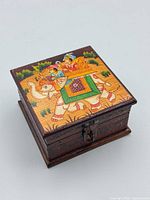 Top view showing painted Rajasthani elephant scene and carved wood