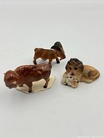 Three miniature animal figurines grouped together