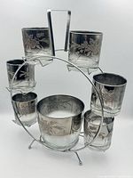 Full view of ferris wheel stand with six glasses and ice bucket displayed