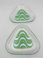 Two clear glass triangular dishes, top view showing decal colours and shape