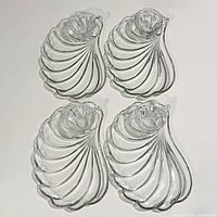 Four shell-shaped trays arranged in grid