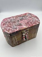 closed wooden trinket box with wax drips and metal latch