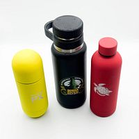 Front view of the three water bottles showing colours, graphics, lids attached