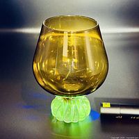 Snifter under UV light showing green uranium glass foot fluorescence