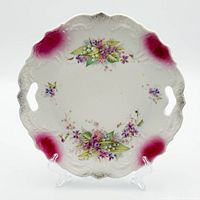 Front view showing floral transfer, magenta corners, embossed rim, handle cutouts