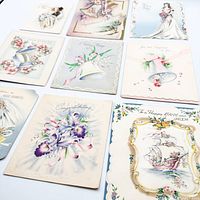 Angled close-up of same nine cards emphasizing embossing and color detail