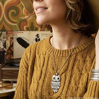 Model wearing articulated owl pendant necklace