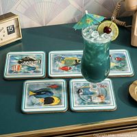 Four cork-backed Pimpernel coasters with tropical fish motifs shown on tabletop