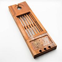 Full view of wooden bath tray showing slatted surface, drawer, cup cutouts and wear