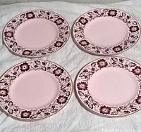 Four Wedgwood Pink Alpine plates front view showing floral border