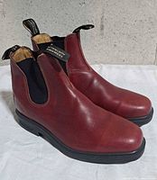 Left side view of both boots showing uppers, soles, and pull tabs