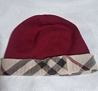 Front view of burgundy knit beanie with Nova Check brim