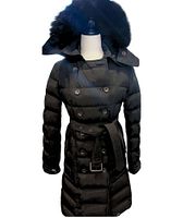 Front view showing double-breasted design, belt, fur hood