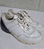 Side view of Chanel white leather/suede sneakers showing overall design and condition
