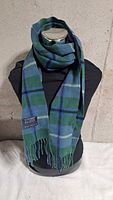 Scarf displayed on mannequin showing tartan pattern and drape