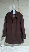 Front view of brown wool coat on hanger