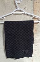 Scarf folded on hanger showing overall colour and pattern