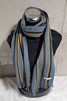 Scarf displayed on mannequin showing full length and stripe pattern