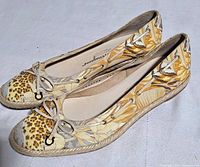 Oblique view of both shoes showing print, laces, rope sole