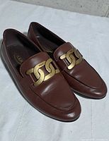 Both loafers angled view showing uppers and chain detail