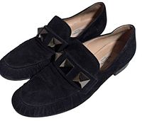 Oblique view of both loafers showing suede texture and studded strap