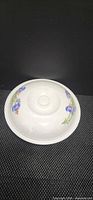 Bowl with lid showing floral pattern