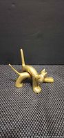 Side view of single brass cat figurine