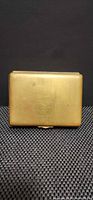 Front view of brass cigarette case closed