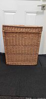 Front view of rectangular rattan hamper with lid closed