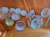 All pressed glass items laid out showing quantity and variety