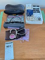 Overview of all items including eyeglasses, cases, jewelry tray, purse hook, bracelet