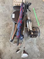 Top view of entire lot showing cart folded, clubs, stool, umbrella, cane