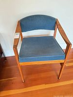 Front view of solid wood armchair with blue upholstery