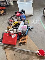 Pile of assorted tools including red case soldering kit, jigsaw, hammer, bit sets, jumper cables, tapes, hardware and metal rods