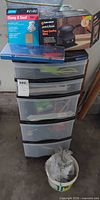 Overall lot showing 5-drawer organizer, sanding block box, sanding sheets pack, compartment case, bucket of hardware