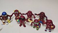 All seven ceramic California Raisins figurines arranged together