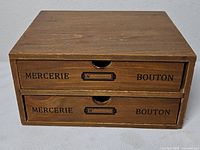 Front view showing two drawers with printed text and label slots