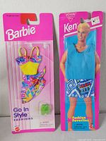 Front view of both sealed Barbie and Ken fashion sets