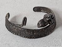 Top view of snake cuff bracelet showing scale texture and open cuff