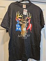 Front view of black North American Outfitters Deer Flag T-shirt with tag