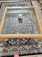 square gold carved wood table with glass top, full view