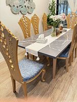 Full view of rectangular quartz dining table showing top pattern and gold legs