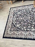 Full view of Persian style rug showing design and condition