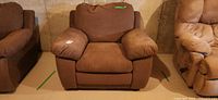 Front view of brown overstuffed armchair