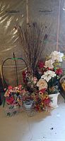 Group shot of all artificial flowers, reeds, metal bicycle planter and trellis