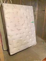 Front view of Serta double mattress standing upright