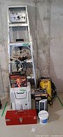 Overall lot showing ladder, cords, toolbox, dehumidifier, pressure washer, heater box, drywall compound