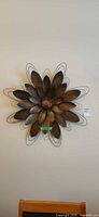 Full view of metal flower wall art mounted on wall