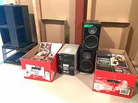 Overall lot showing CD racks, two boxes of CDs, Sharp stereo with speakers