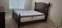 Assembled queen bed with mattress showing frame and overall appearance